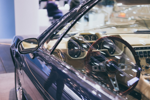 How does enclosed transport protect luxury vehicles